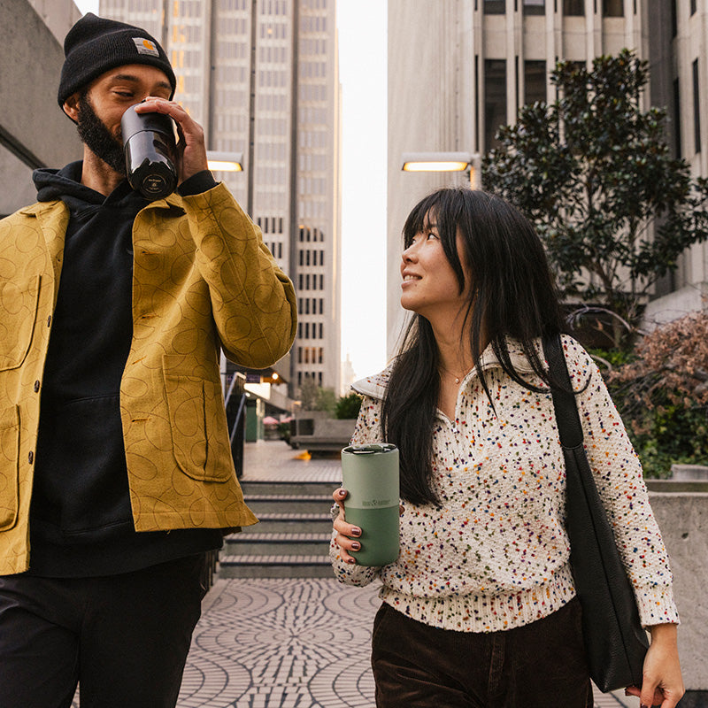 16oz-rise-tumbler-t2 16oz_rise_tumbler_black_iceberg_couple_drink_city_street_square.jpg